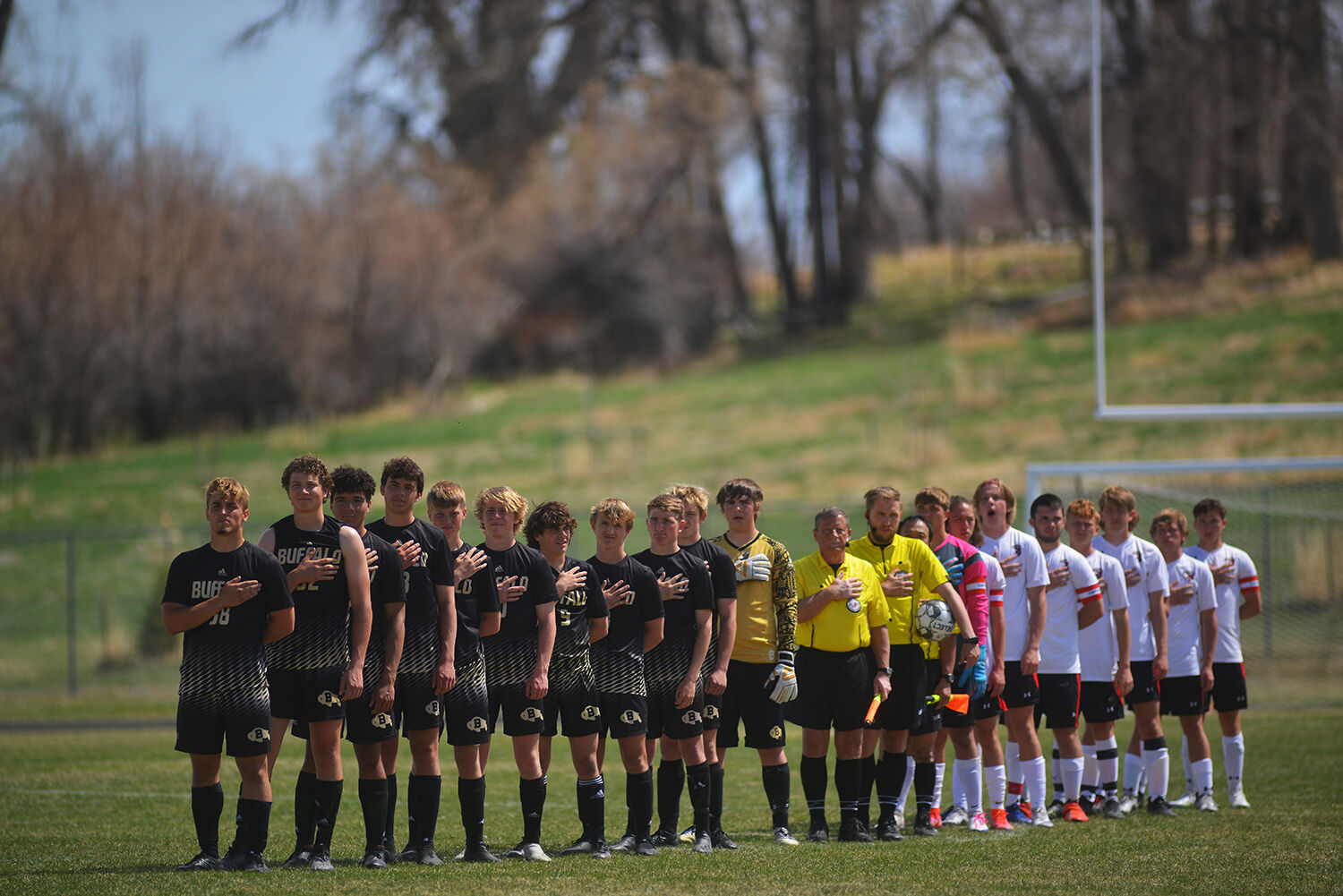Buffalo and Riverton boys varsity teams lined up for the singing